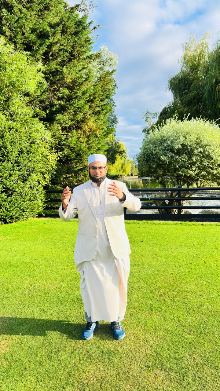 Hafiz Abdul Hoque speaking outdoors during a community gathering